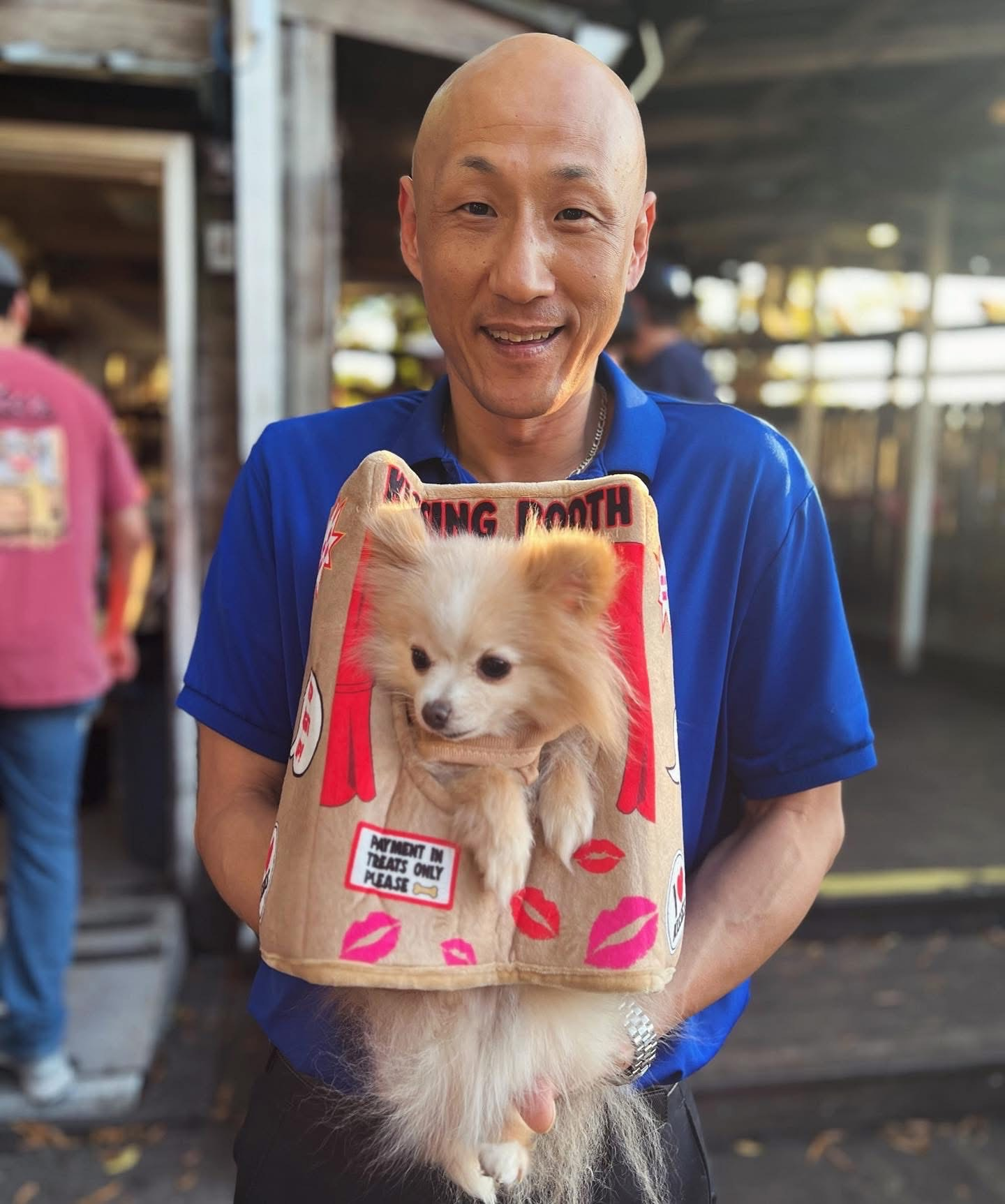 Jung Pak holding a dog during Yappy Hour at Jake's in Columbia South Carolina